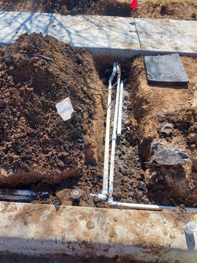 sprinkler line under sidewalk
